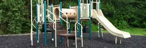 playground on top of rubber mulch with woods in background