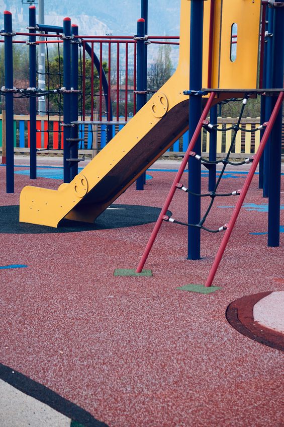 A playground with a rubber mulch surface