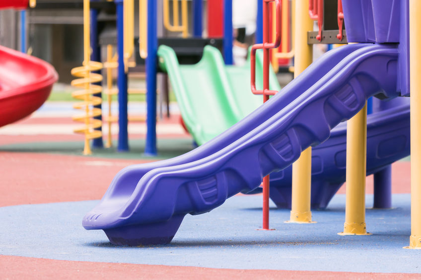 A playground with a rubber mulch surface